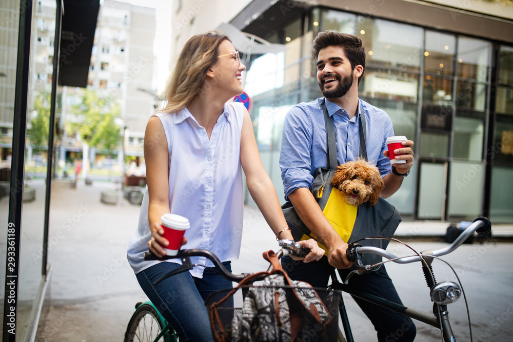 Happy young couple spending time together with dog and bicycles Happy young couple spending time together with dog and bicycles