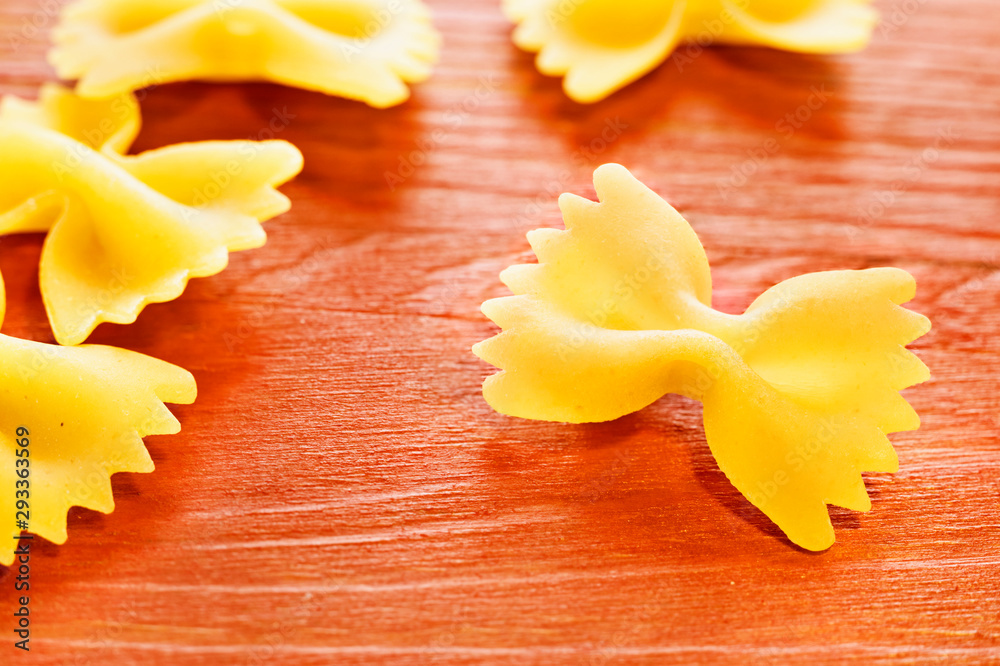 Pasta farfalle on colored background