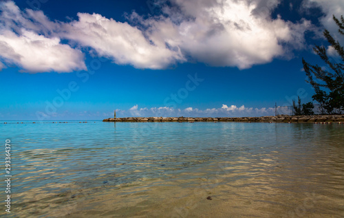 Jamaica Beach with Clouds. Exposure done by the sea of a beach in Montego  Bay  Jamaica  with beautiful water and clouds.