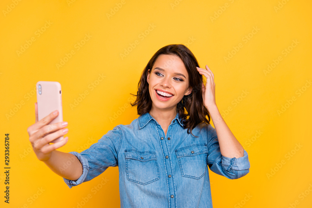 Hey everyone my followers. Portrait of positive cheerful girl photographer blogger have fun on travel trip vacation make selfie with smartphone wear stylish outfit isolated over yellow color