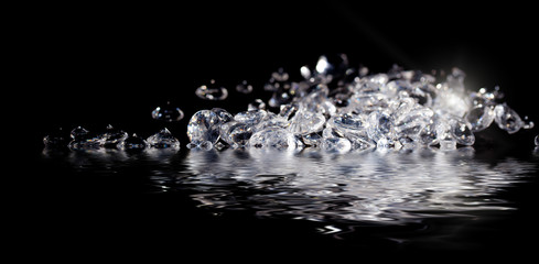 Diamonds reflecting in water on black
