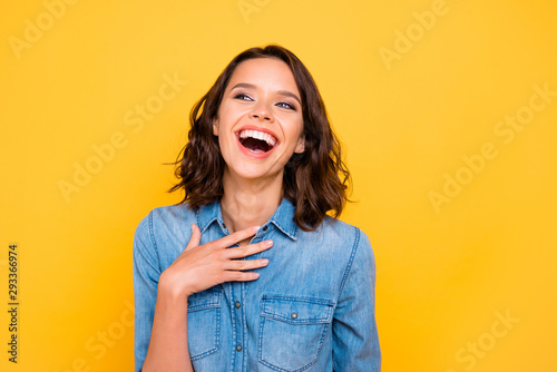 You are so funny. Portrait of cheerful positive funny funky girl hear joke laugh wear youth clothses isolated over yellow bright color background photo