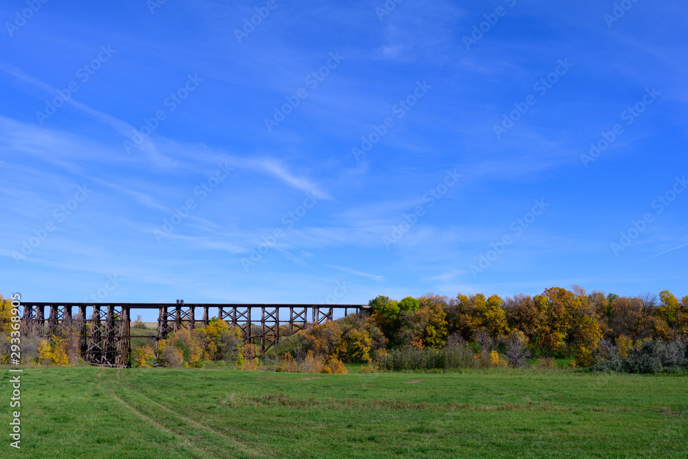 train trestle with trees and blue sky