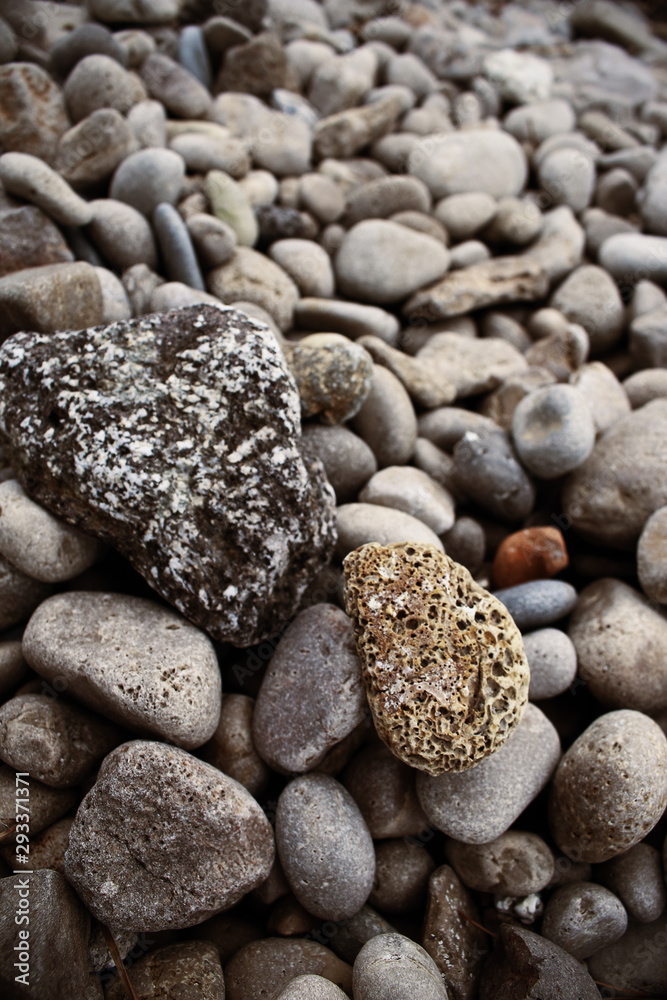 Vertical sea beach textured surface stones background Vertical sea beach textured surface stones background