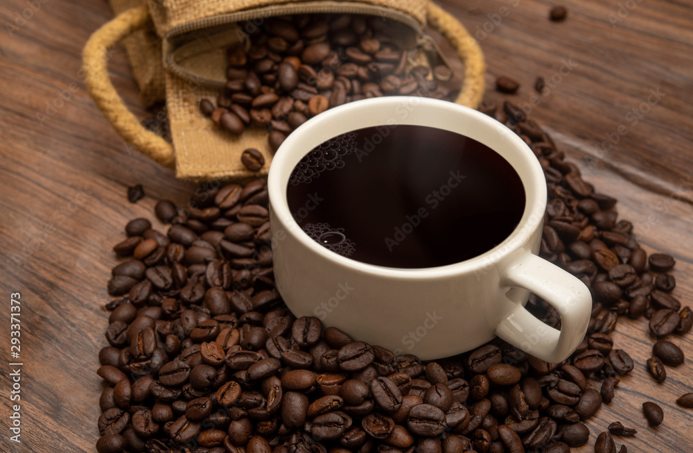 Cup of coffee beans and burlap sack on wooden background, copy space banner Cup of coffee beans and burlap sack on wooden background, copy space banner