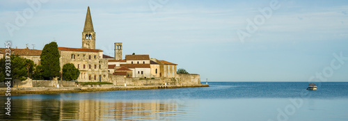 Ancient stone town located on the Peninsula. The city is surrounded by the sea, ancient buildings reflected on the water. Istria, Croatia, Porec.