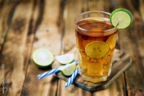 iced tea cocktail with strong drinks, wood background