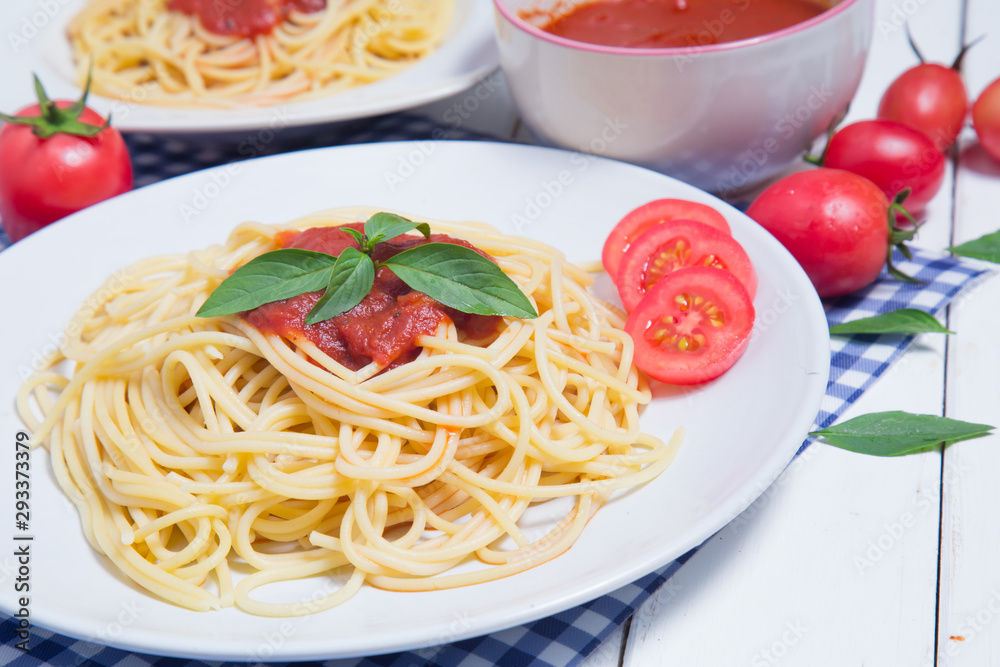 Spaghetti pasta with and tomato sauce on wood background Spaghetti pasta with and tomato sauce on wood background
