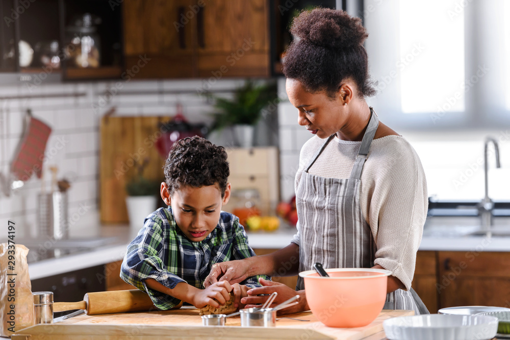 Mother and son baking together. American family. Single mother. Child helping mother. Mother and son baking together. American family. Single mother. Child helping mother.