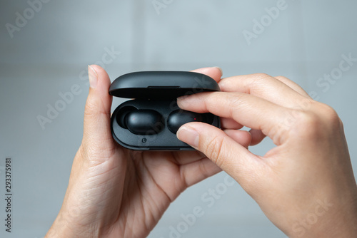 Wallpaper Mural Close up of woman is open the black true wireless earbuds case Torontodigital.ca