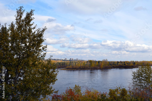 The wide Yenisei river. Krasnoyarsk region. Nature Of Siberia. Beautiful autumn landscape. A lot of yellow leaves on the trees.