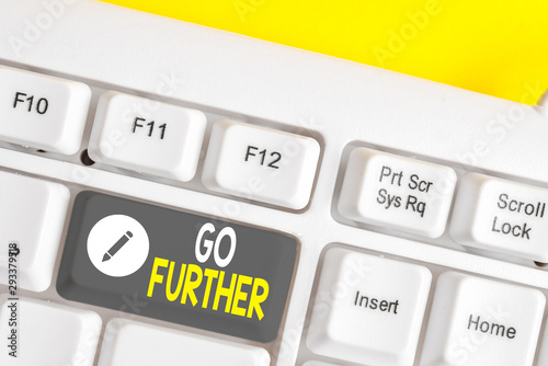 Writing note showing Go Further. Business concept for To move to a greater distance or overcome your limitations White pc keyboard with note paper above the white background photo