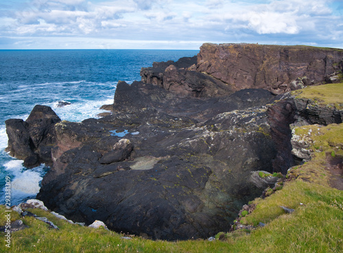 Coast rock formations at Eshaness on Shetland, Scotland, UK - the rocks are of the Eshaness Volcanic Formation - andesite, augite - igneous bedrock formed  in the Devonian Period. 