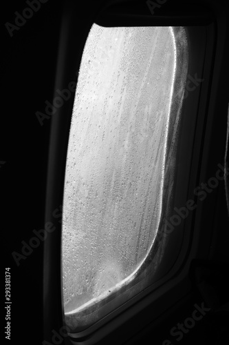 drops of rain on the airplane window during the flight black and white