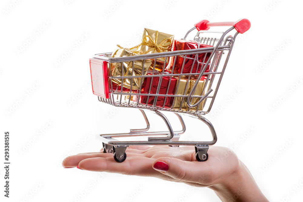 Shopping cart filled with presents isolated on white background. Christmas, birthday and sale concept. Shopping cart filled with presents isolated on white background. Christmas, birthday and sale concept.