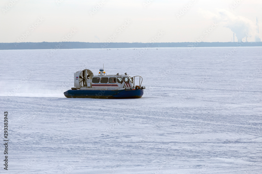 Naklejka premium Boat hovercraft on white ice snow in winter.