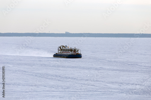 Boat hovercraft on white ice snow in winter.