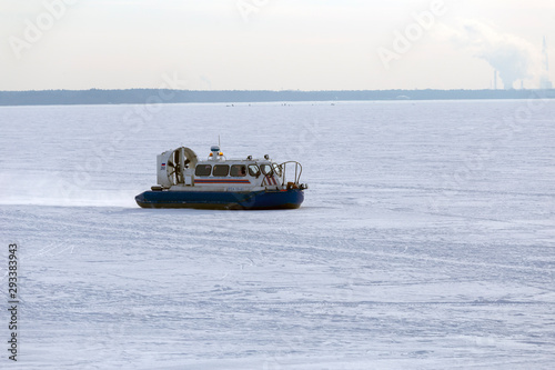 Boat hovercraft on white ice snow in winter.