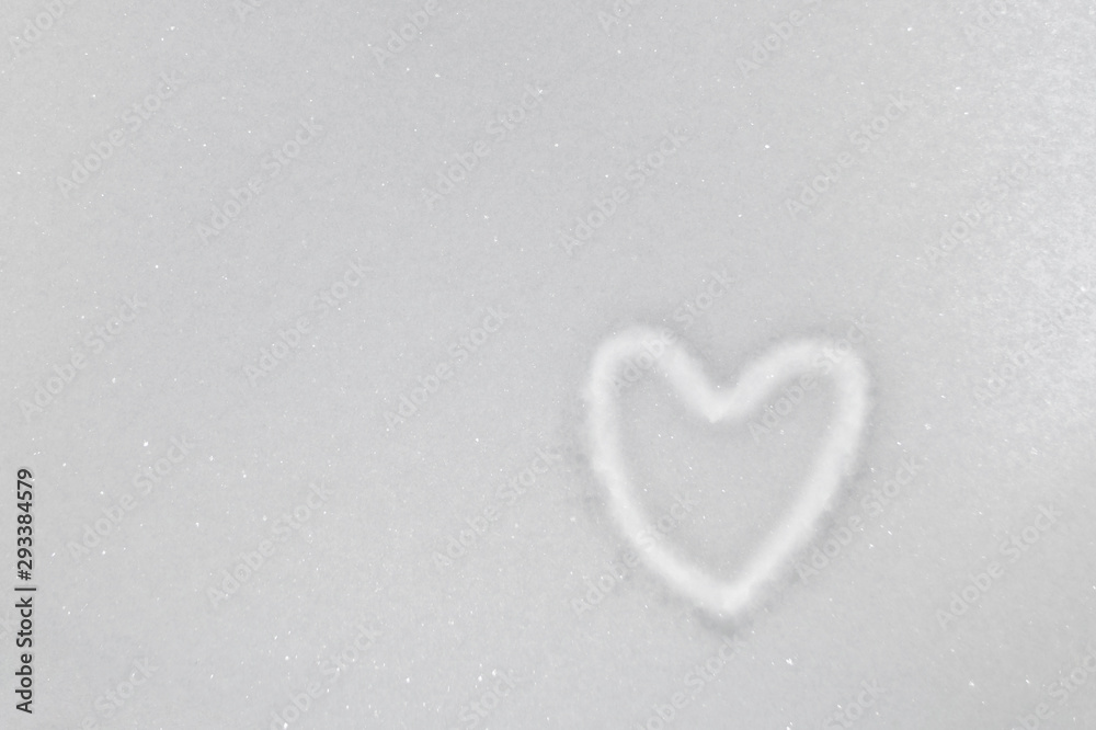 White snow with drown heart shape winter day closeup