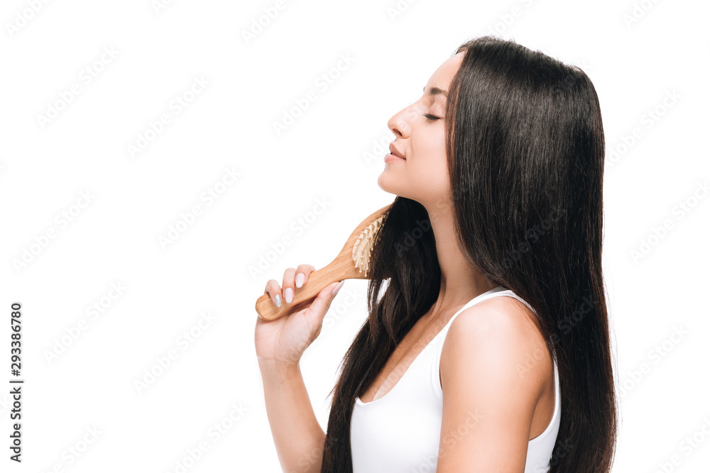side view of brunette beautiful woman with closed eyes brushing long straight healthy and shiny hair with comb isolated on white side view of brunette beautiful woman with closed eyes brushing long straight healthy and shiny hair with comb isolated on white