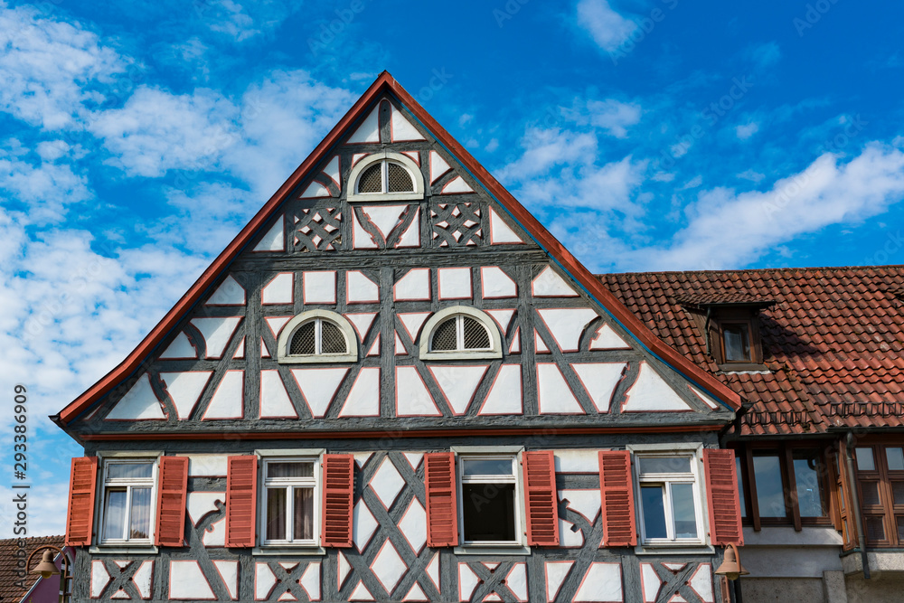 White half timbered house with orange shutters in Untermunkheim, Germany White half timbered house with orange shutters in Untermunkheim, Germany