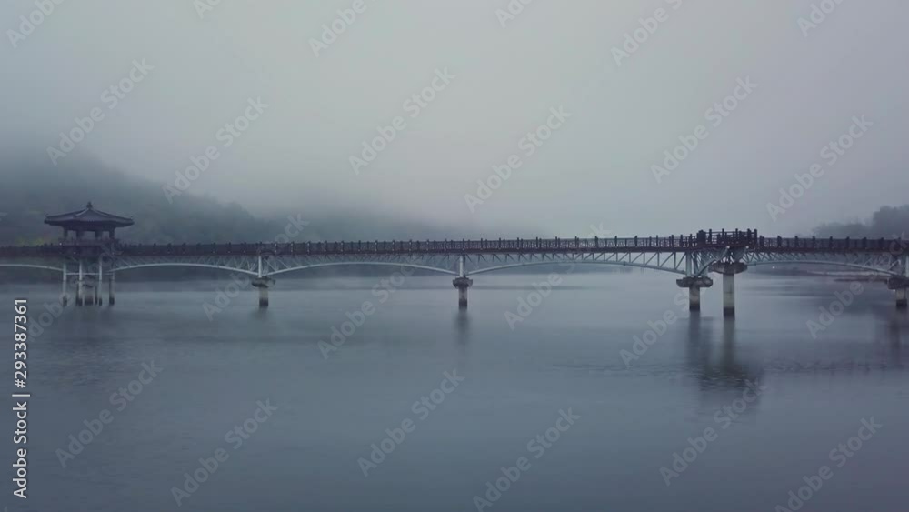 Aerial video of Wolyeonggyo bridge is located in the midst of Nakdong river in the morning during Autumn season at Andong city, South Korea. Aerial video of Wolyeonggyo bridge is located in the midst of Nakdong river in the morning during Autumn season at Andong city, South Korea.