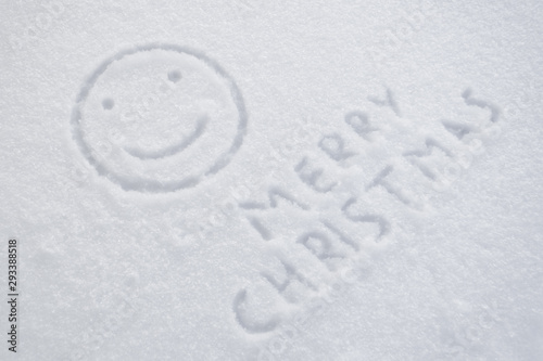 text merry christmas and smiley on snow