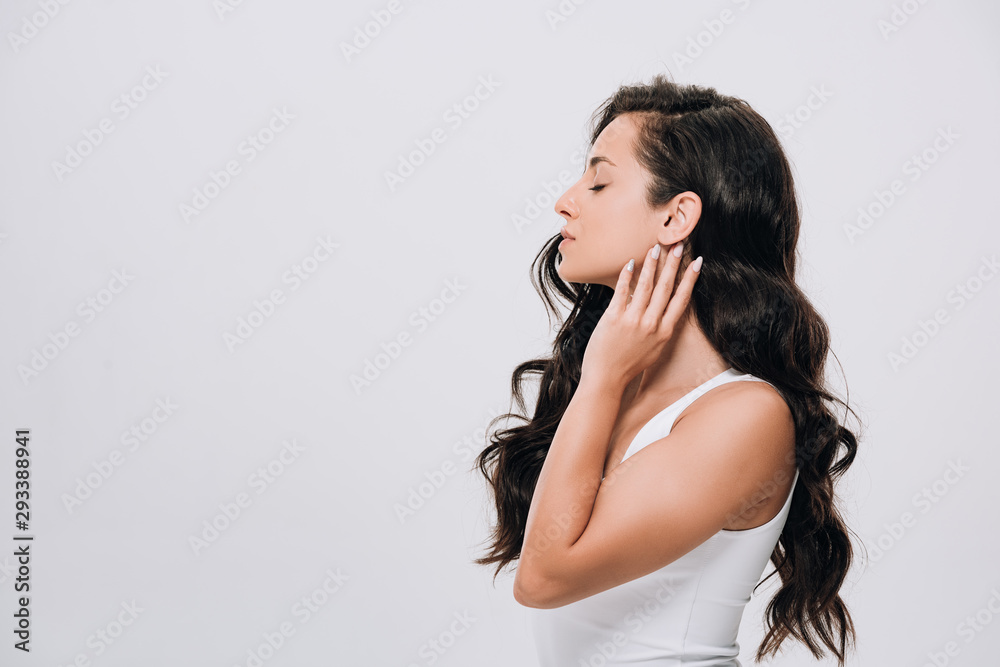 side view of brunette beautiful woman with long curly healthy hair isolated on grey side view of brunette beautiful woman with long curly healthy hair isolated on grey