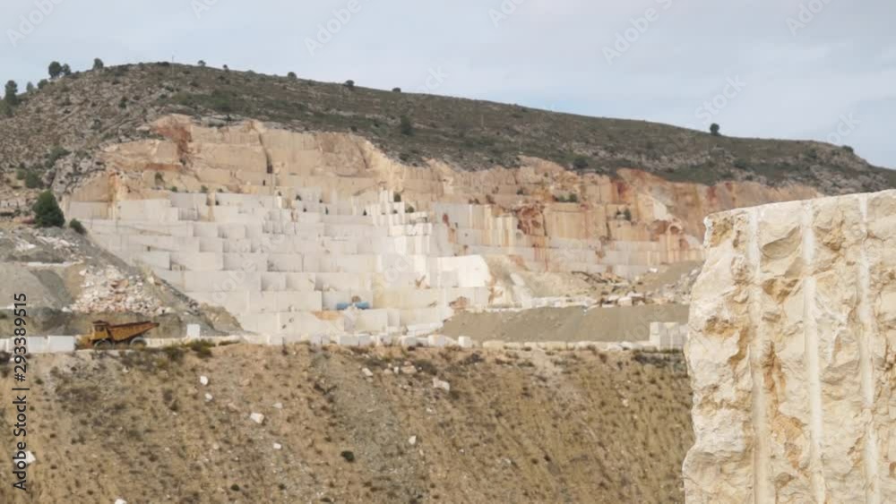 Industrial Marble Quarry Site With Huge Marble Blocks and loader truck on the street. Wide shot. Industrial Marble Quarry Site With Huge Marble Blocks and loader truck on the street. Wide shot.