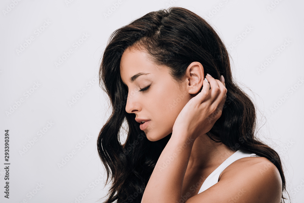 side view of tender brunette beautiful woman with long healthy and shiny hair isolated on grey side view of tender brunette beautiful woman with long healthy and shiny hair isolated on grey