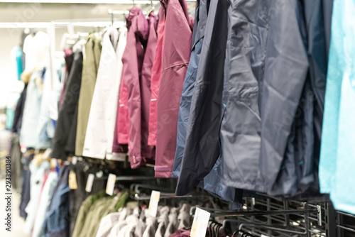 Clothing store. Jackets and raincoats on store shelve. A range of clothing with a large selection.