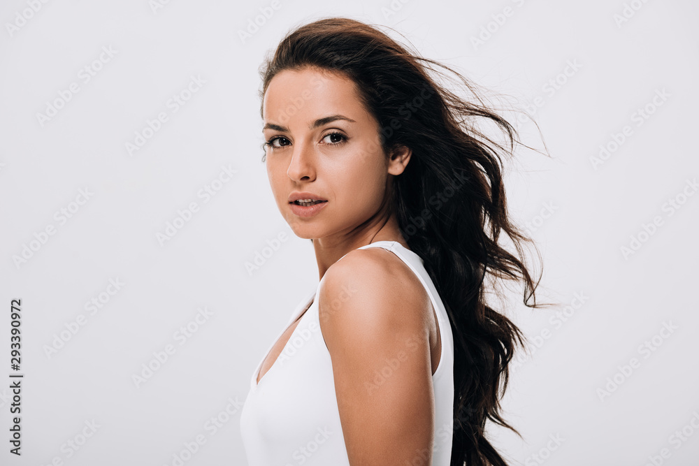 brunette beautiful woman with long healthy and shiny hair isolated on grey