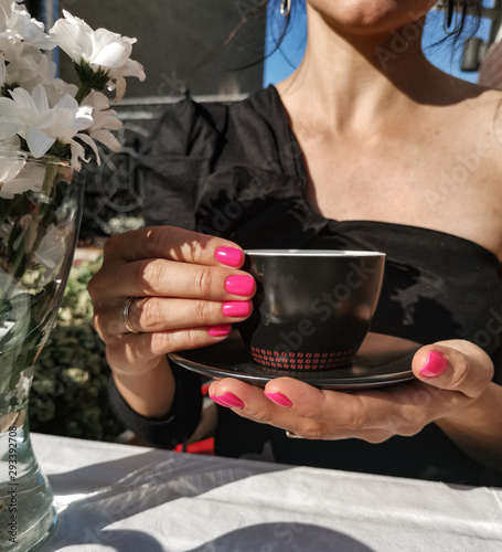 Beauty Portrait Model Hands with a Mug of Delicious Coffee closeup. Cold Drink Tea with Lemon in Hands close up 