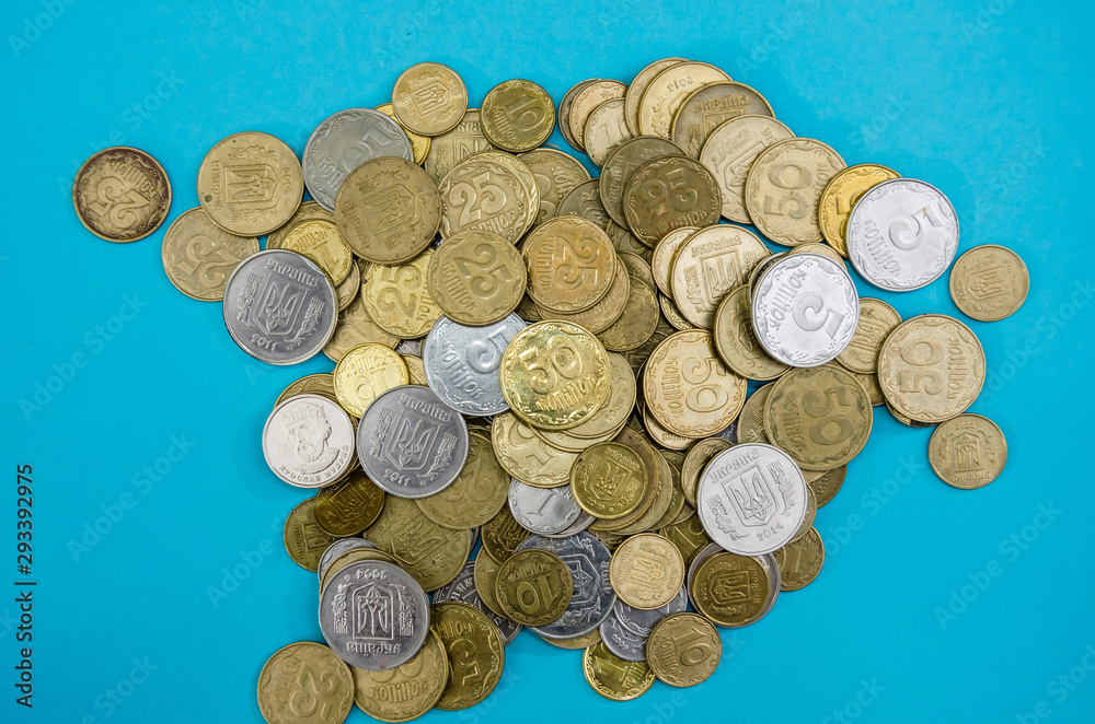 a lot of Ukrainian coins on a blue background. Close-up. a lot of Ukrainian coins on a blue background. Close-up.