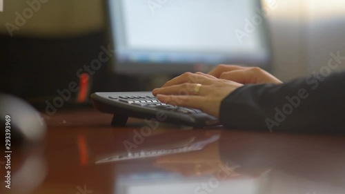 Female Hands Typing On Computer Keyboard in office photo