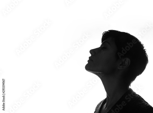 profile of a woman with short black hair on white background