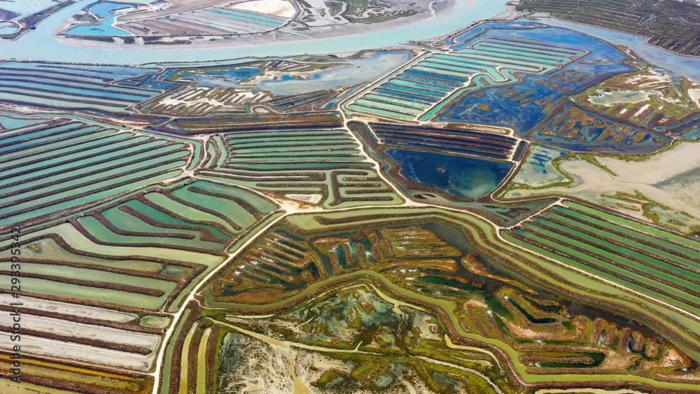 Old canals where seawater is processed to produce sea salt, a wonderful natural food and an important product - aerial view with a drone - landscape, textured and graphic concept 4K Old canals where seawater is processed to produce sea salt, a wonderful natural food and an important product - aerial view with a drone - landscape, textured and graphic concept 4K