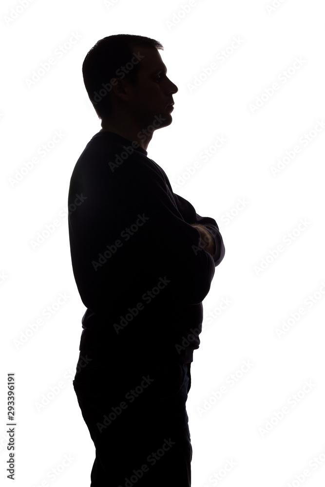 Portrait of a young man, side view - dark isolated silhouette