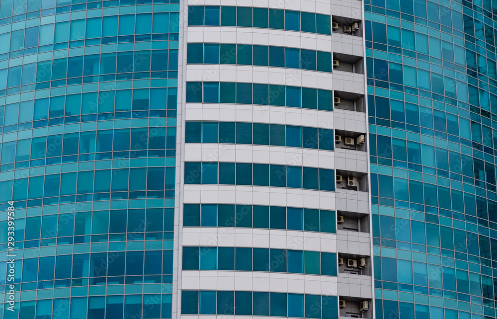 The wall of a high-rise building of glass and concrete. The wall of a high-rise building of glass and concrete.