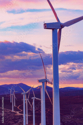Wind turbines spinning at sunset