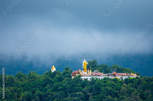 Wat Phra That Doi Kham Old temple and holy Buddha statue on mountain at Wat Phra That Doi Kham temple, Chiang Mai , Thailand. photo