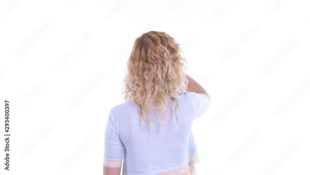 Rear view of blonde woman touching something Rear view of blonde woman touching something