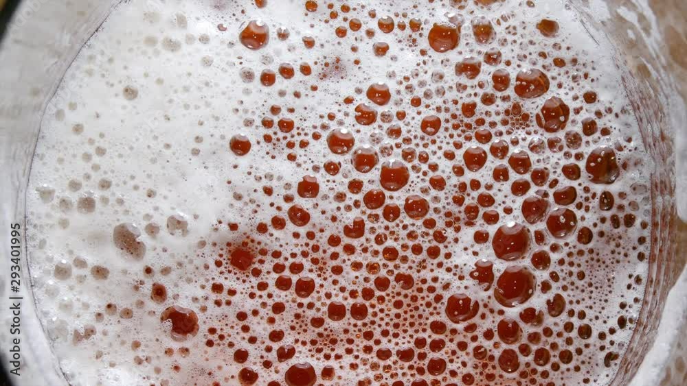 Dissipating Beer Foam in Glass, View From Above Dissipating Beer Foam in Glass, View From Above