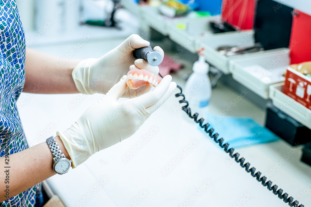 Prosthetics hands while working on the denture Prosthetics hands while working on the denture