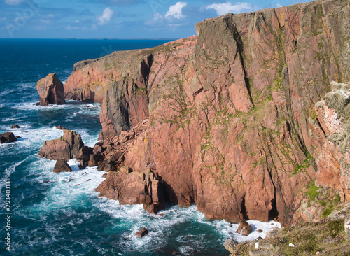 Sea cliffs near North Ham on Muckle Roe, Shetland, UK - the rock is of the Muckle Roe Intrusion - granite, granophyric - igneous bedrock formed in the Devonian Period. photo
