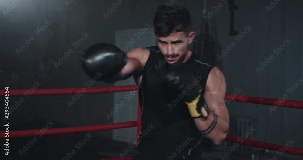 Charismatic boxing man in the front of the camera he have a intense workout training Charismatic boxing man in the front of the camera he have a intense workout training