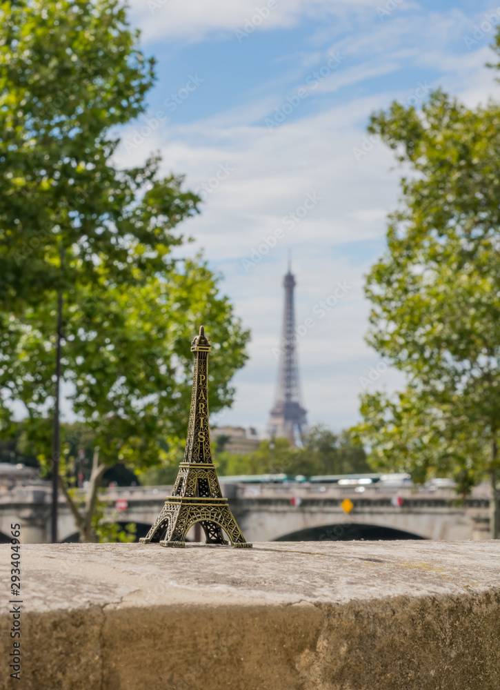 Small Eifel tower on the real Eiffel tower background