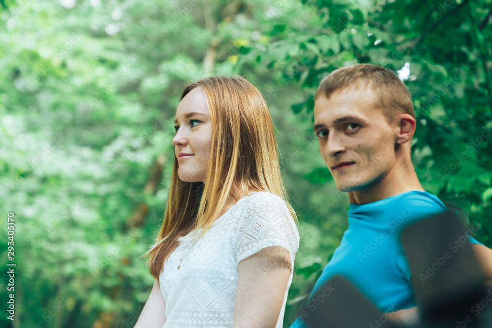 A guy and a girl are walking in the park