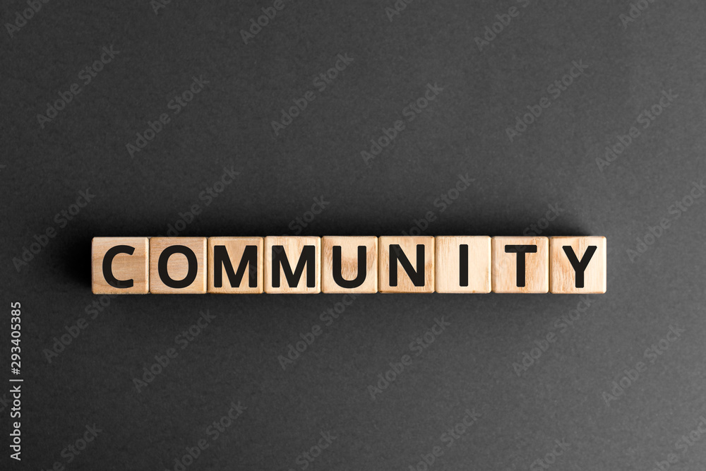 Community - word from wooden blocks with letters, group of people community concept, random letters around, top view gray background Community - word from wooden blocks with letters, group of people community concept, random letters around, top view gray background