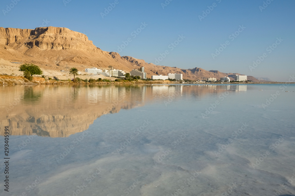 Dead Sea tourist resort of Ein Bokek reflected in the salt water